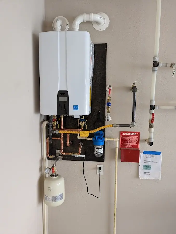 Professional plumber installing copper piping in a Green Valley home